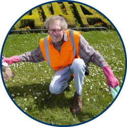 A man in a hi-vis vest smiles