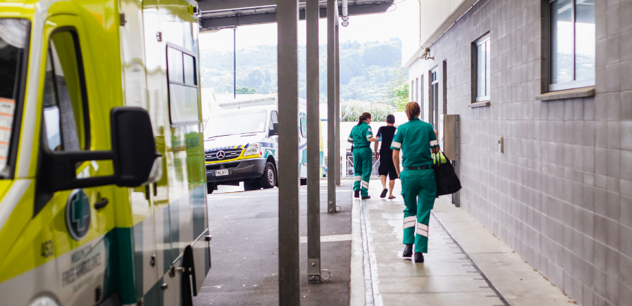 A paramedic walks towards an emergency department