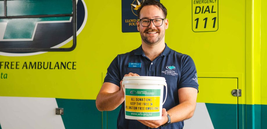 A paramedic holds a collection bucket