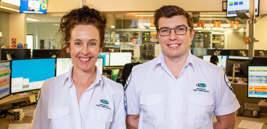 Two call takers in call centre smiling at camera