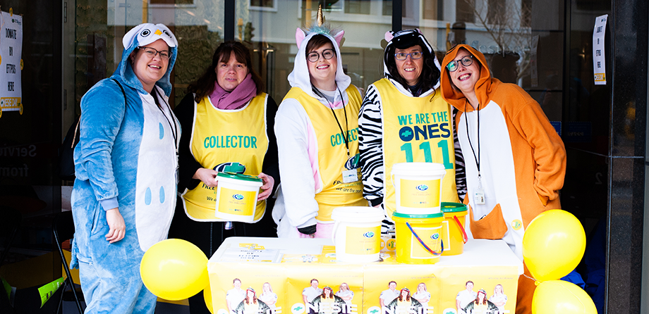 Five volunteer collectors dressed up in their onesies