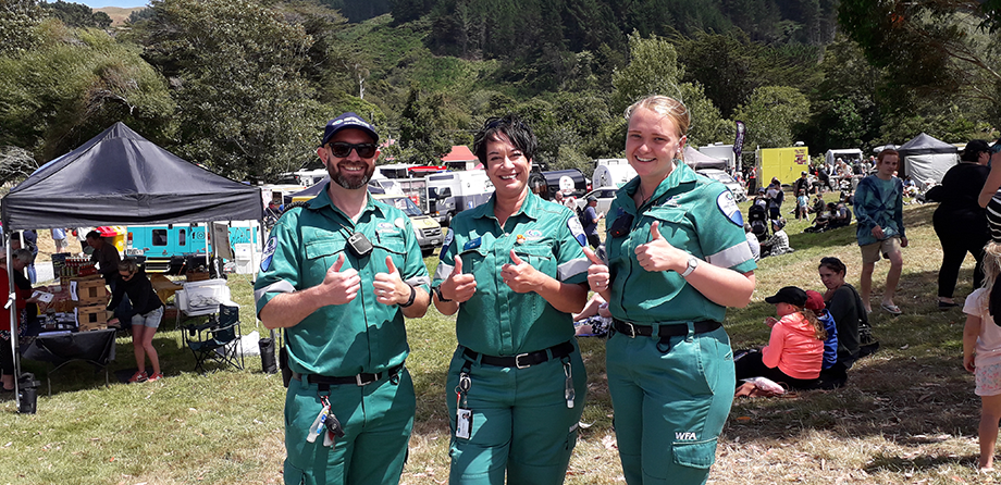 Three smiling event medics with thumbs up