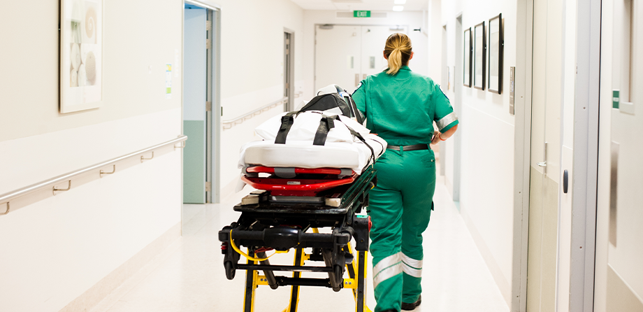 Paramedic pulling a stretcher