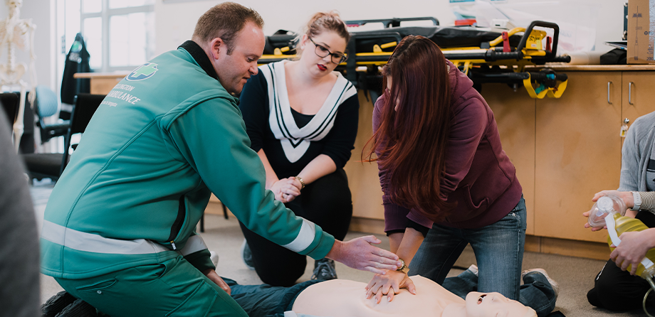 People learning CPR at a Heartbeat training session.