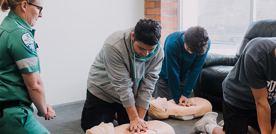 People learning CPR during a Heartbeat training session.