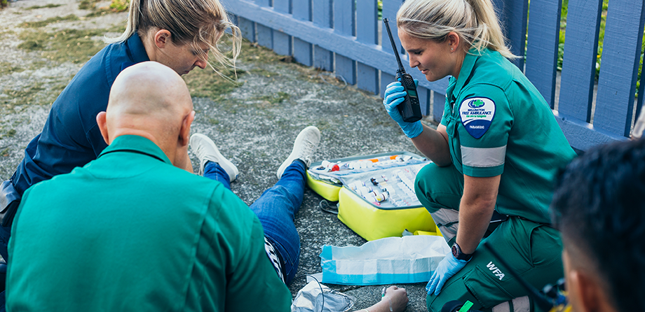 Paramedics working with a patient on a cardiac arrest demonstration
