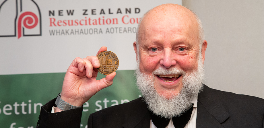 Dr Andy Swain holding the Sir David Hay Medal