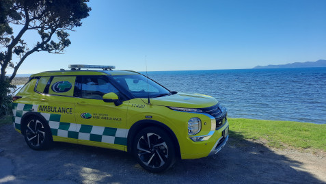 A yellow Critical Care vehicle at a beach