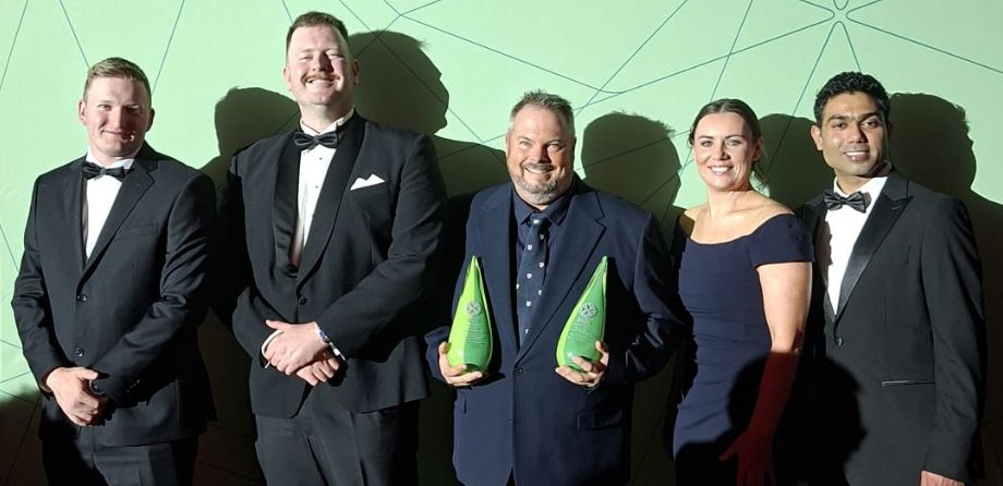 Wellington Free Ambulance staff smile while holding 2 awards