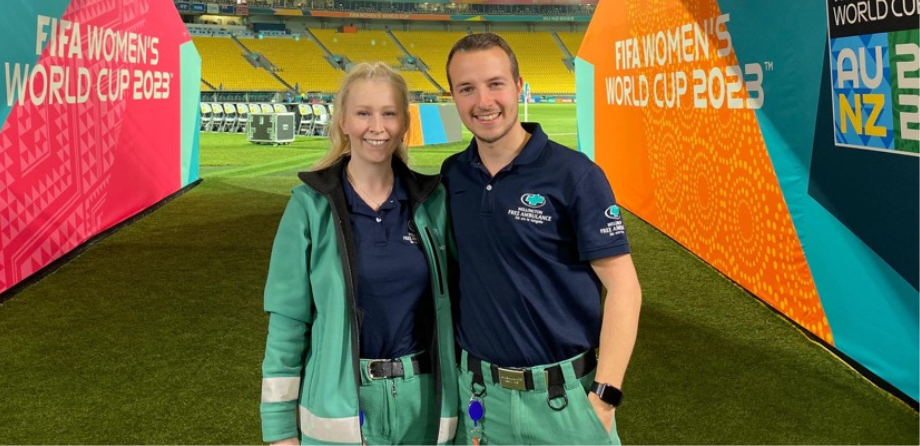 2 paramedics smile in front of signs for FIFA Women's World Cup 2023