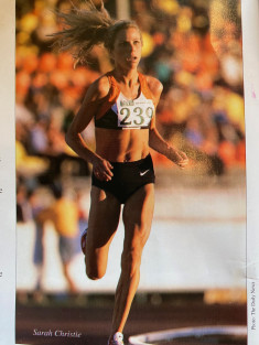 A woman runner with the number 239