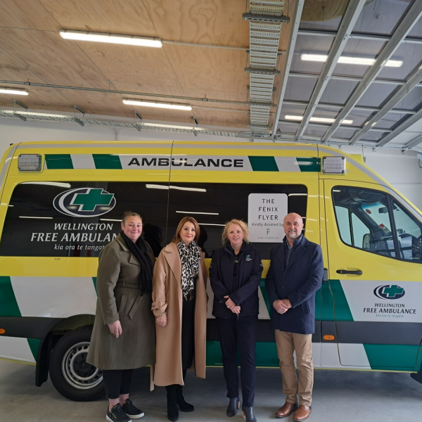 4 people stand in front of The Fenix Flyer, a new ambulance