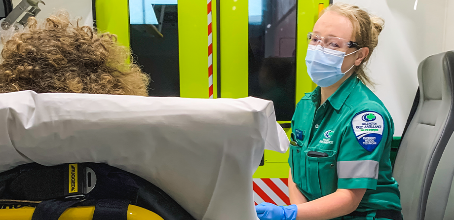 Paramedic wearing face mask in ambulance