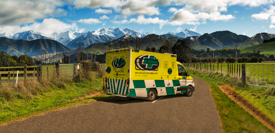 Wellington Free Ambulance in front of snowy mountains