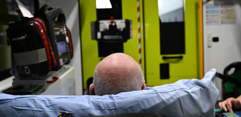 The back of a patient on a stretcher in an ambulance