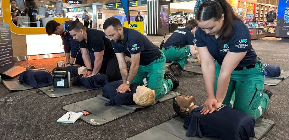 A row of paramedics performing CPR on mannikins