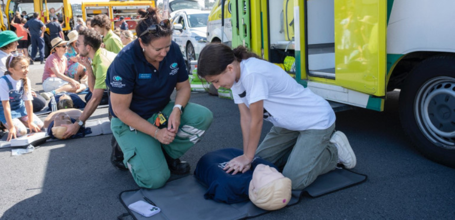 A young person performs CPR on a mannikin