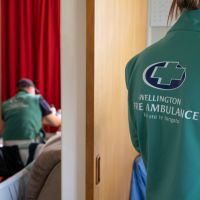 The back of a paramedic in a doorway