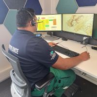 The back of a Clinical Paramedic Advisor in front of screens