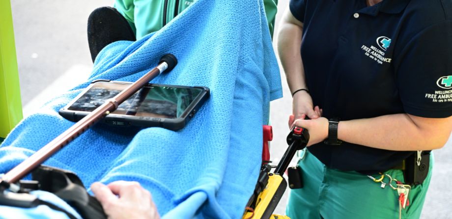 A paramedic next to a patient on a stretcher