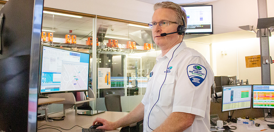 Emergency medical dispatcher looking at computer screen